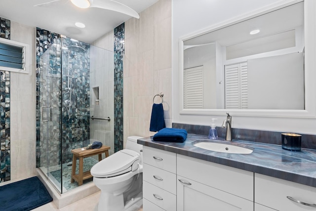 bathroom with tile patterned floors, vanity, toilet, and walk in shower