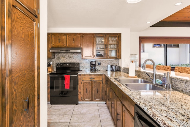 kitchen featuring backsplash, sink, light stone countertops, electric range, and light tile patterned floors