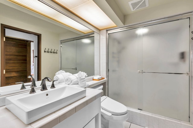 bathroom with vanity, a shower with shower door, toilet, and tile patterned flooring