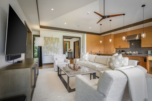 living room with a raised ceiling and light wood-type flooring