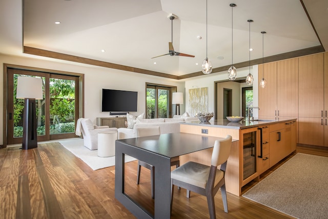 interior space with wine cooler, a healthy amount of sunlight, hardwood / wood-style flooring, and ceiling fan