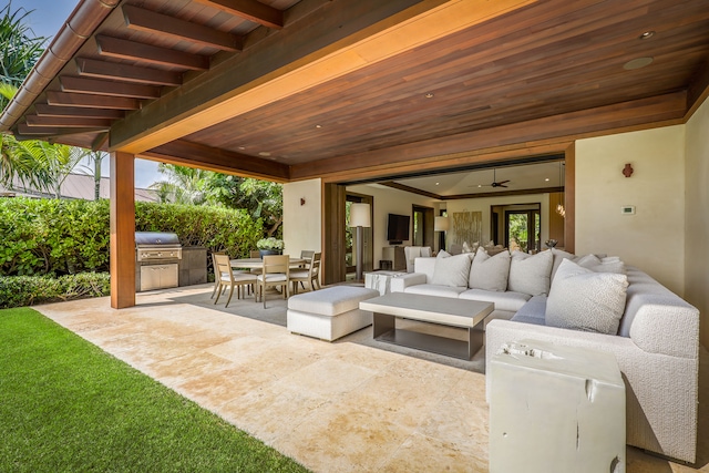 view of patio with an outdoor living space, area for grilling, and ceiling fan