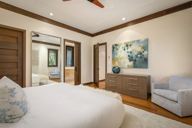 bedroom featuring dark wood-type flooring, ceiling fan, and connected bathroom