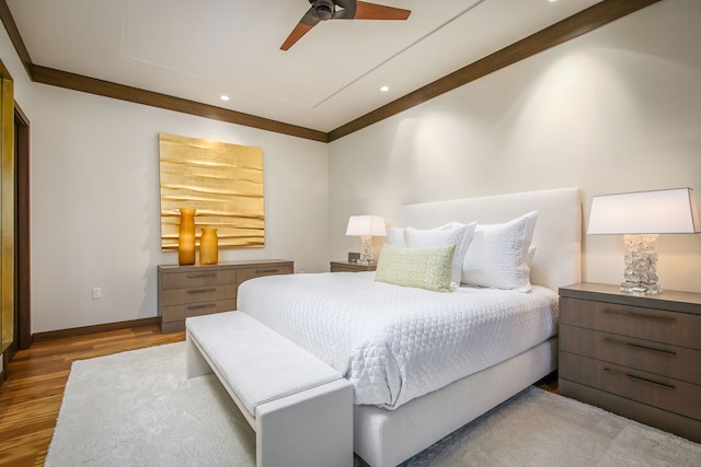 bedroom with ceiling fan, ornamental molding, and hardwood / wood-style floors