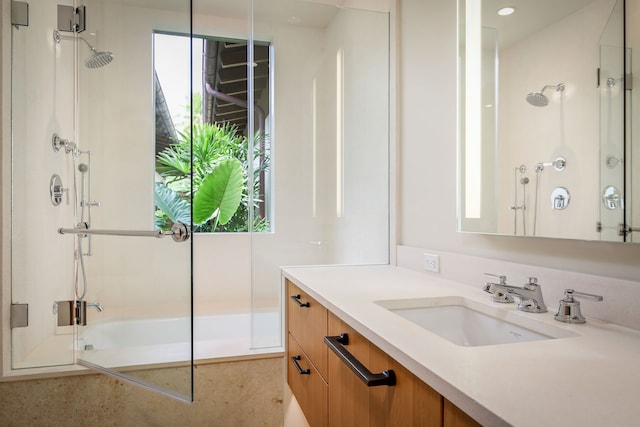 bathroom with vanity and tiled shower / bath