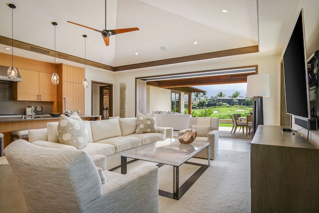 living room featuring light hardwood / wood-style flooring, high vaulted ceiling, and ceiling fan