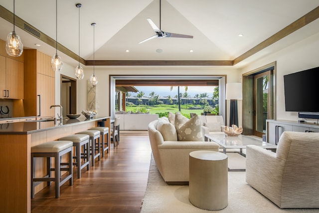 living room featuring hardwood / wood-style flooring, high vaulted ceiling, and ceiling fan