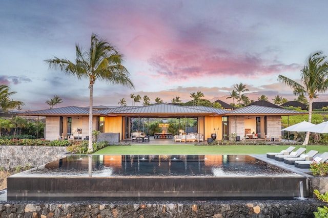 back house at dusk with a patio