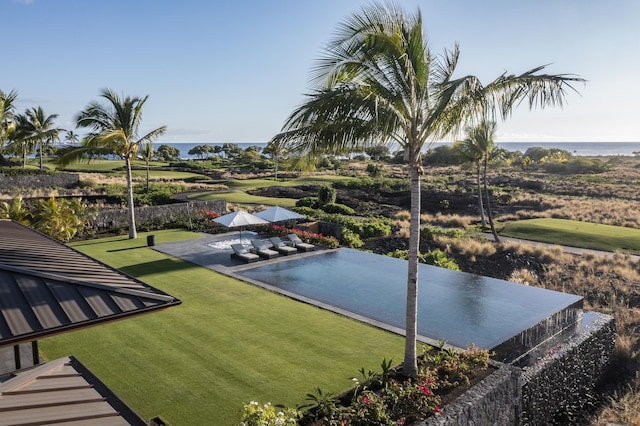 view of pool featuring a patio, a water view, an outdoor hangout area, and a yard