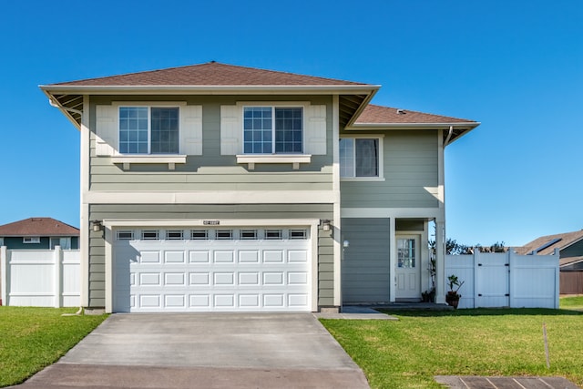 view of front property featuring a front yard and a garage