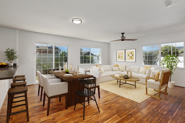 dining space featuring ceiling fan, a healthy amount of sunlight, and dark hardwood / wood-style flooring