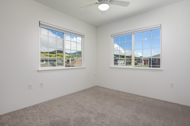 unfurnished room featuring carpet flooring and ceiling fan