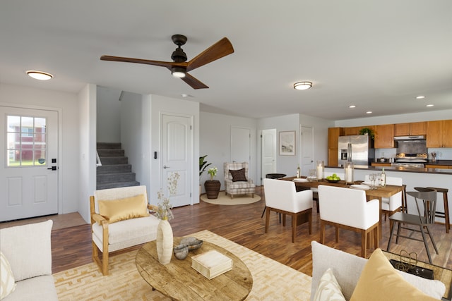 living room with ceiling fan and light wood-type flooring