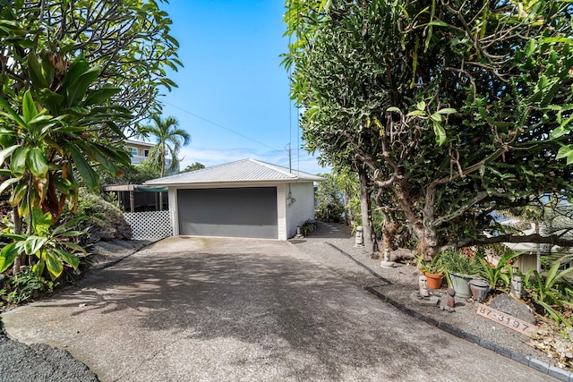 exterior space featuring a garage and an outdoor structure