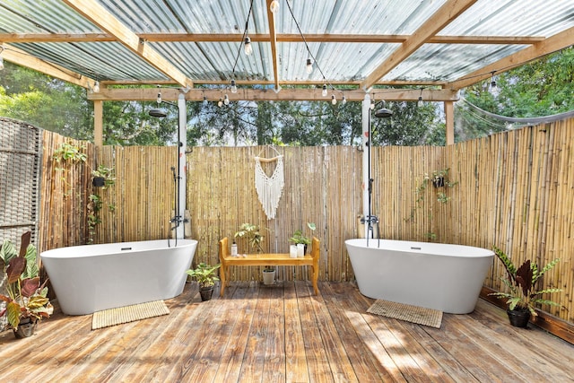 bathroom with hardwood / wood-style flooring, wooden walls, and a tub