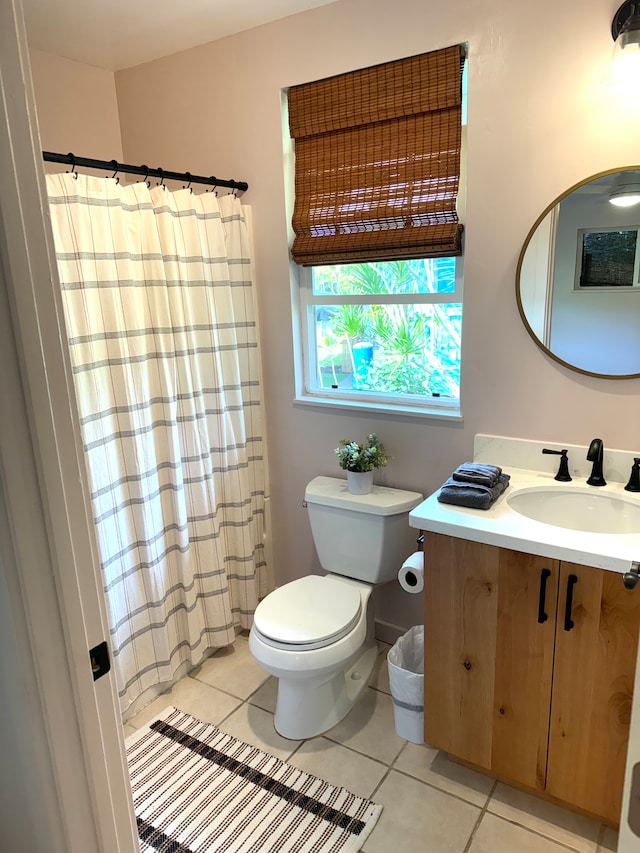 bathroom with toilet, a shower with curtain, vanity, and tile patterned flooring