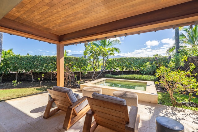 view of patio / terrace with an outdoor hot tub