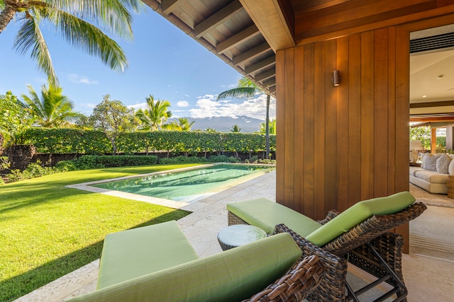 exterior space featuring a swimming pool, a patio area, and a yard