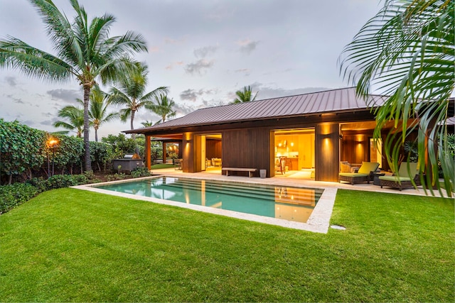 rear view of house with a patio area, outdoor lounge area, and a yard