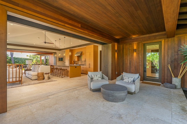 view of patio featuring ceiling fan and an outdoor bar