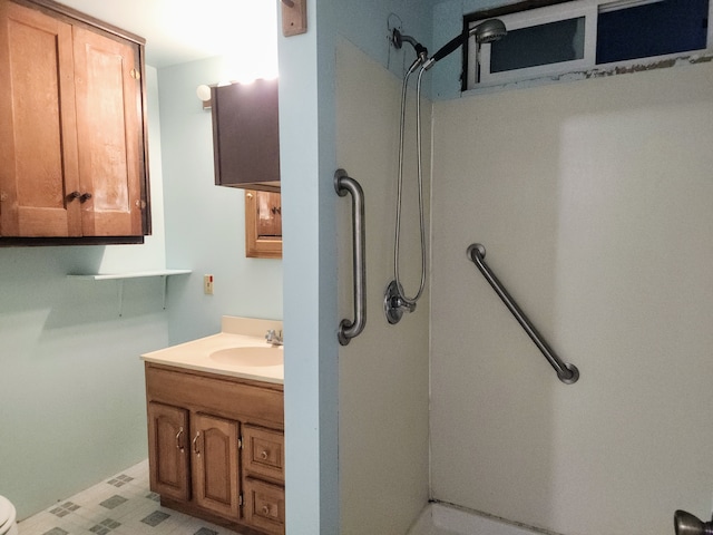 bathroom with vanity, toilet, and a shower