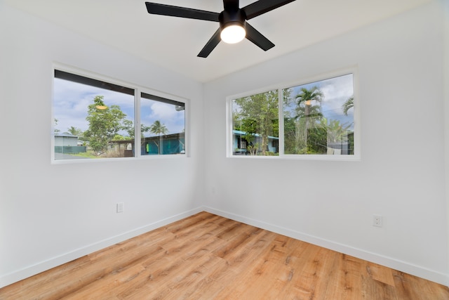 spare room with light wood-type flooring and ceiling fan