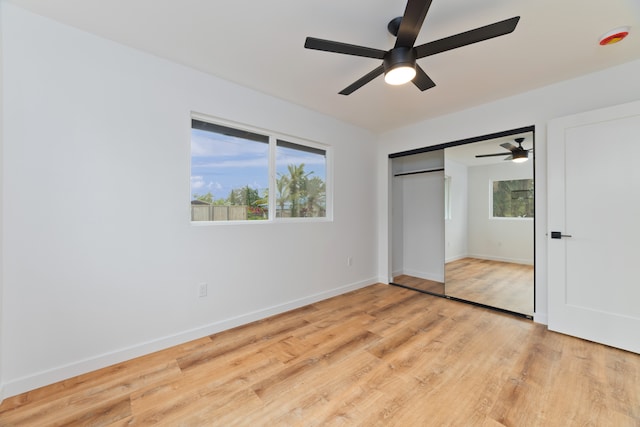 unfurnished bedroom featuring a closet, light wood-type flooring, and ceiling fan