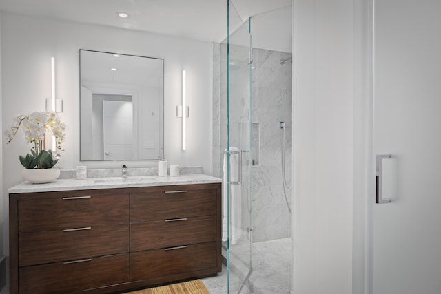 bathroom featuring walk in shower and vanity