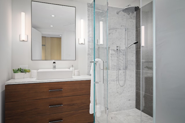 bathroom featuring walk in shower and vanity