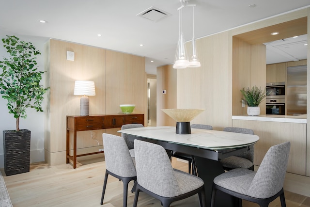 dining area with light hardwood / wood-style floors