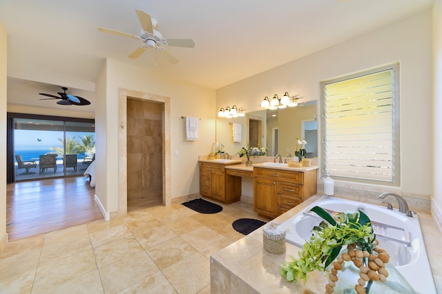 bathroom featuring tile patterned flooring, ceiling fan, separate shower and tub, and vanity