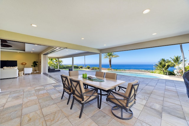 dining room with a water view and a wealth of natural light