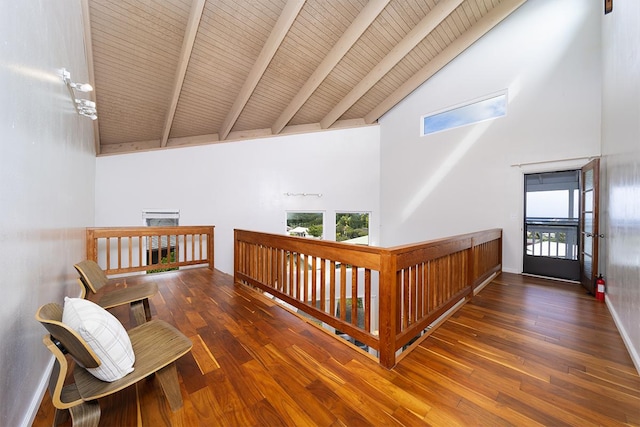 hallway with dark hardwood / wood-style flooring, beamed ceiling, wooden ceiling, and high vaulted ceiling