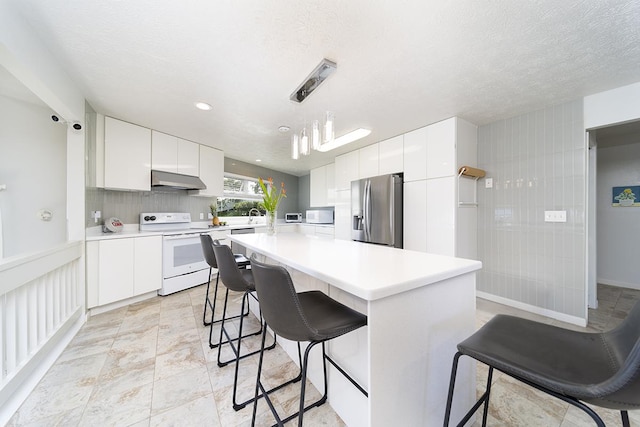 kitchen with pendant lighting, exhaust hood, a kitchen island, white cabinetry, and stainless steel appliances