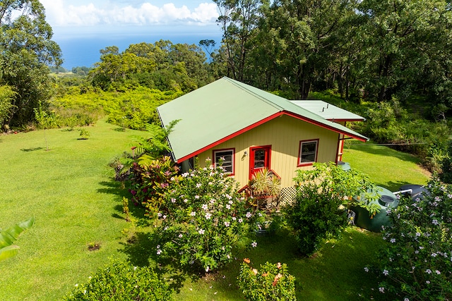 view of side of home featuring a lawn