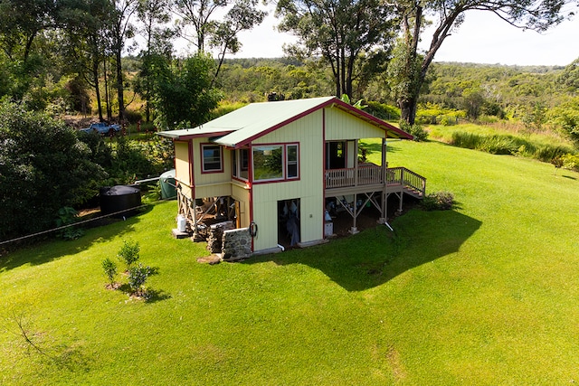 rear view of house with a yard and a deck