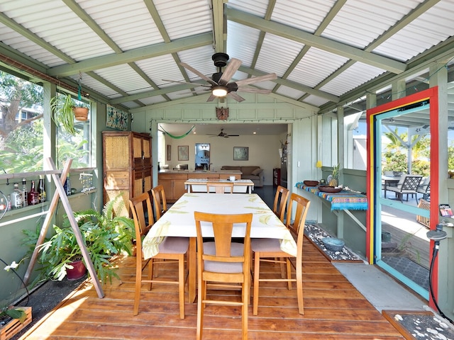 sunroom featuring lofted ceiling with beams and ceiling fan