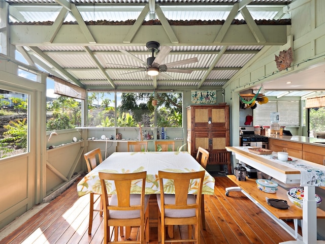 sunroom with a wealth of natural light, vaulted ceiling, and ceiling fan