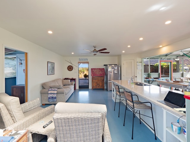 living room featuring sink and ceiling fan