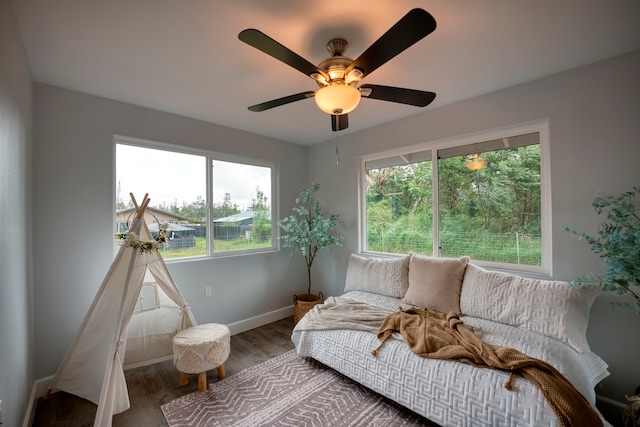 sitting room with wood-type flooring and ceiling fan