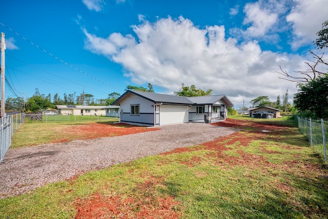 single story home with a front yard and a garage