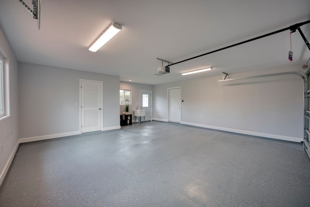 garage featuring sink and a garage door opener