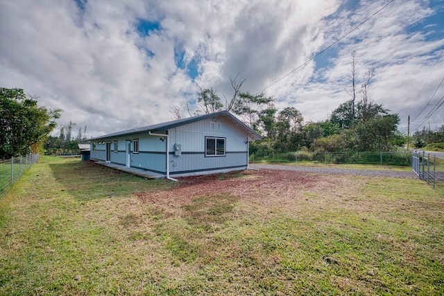 view of side of home with a yard