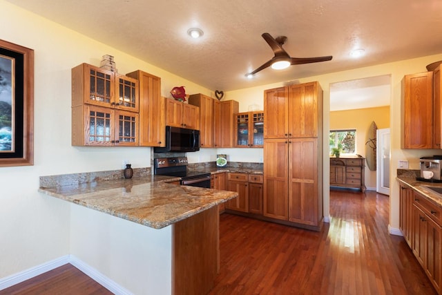 kitchen with kitchen peninsula, stainless steel electric stove, ceiling fan, stone counters, and dark hardwood / wood-style floors