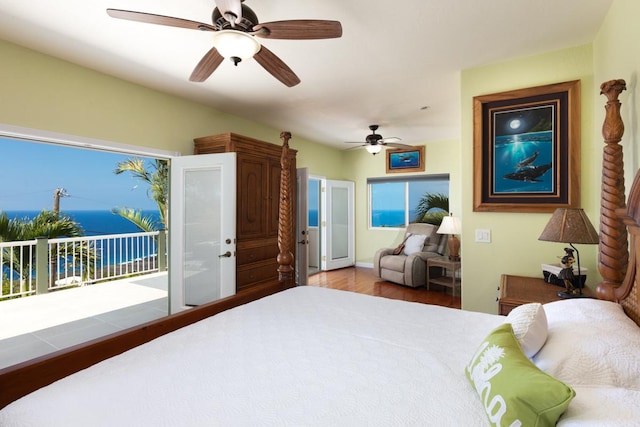 bedroom featuring hardwood / wood-style flooring, ceiling fan, and access to outside