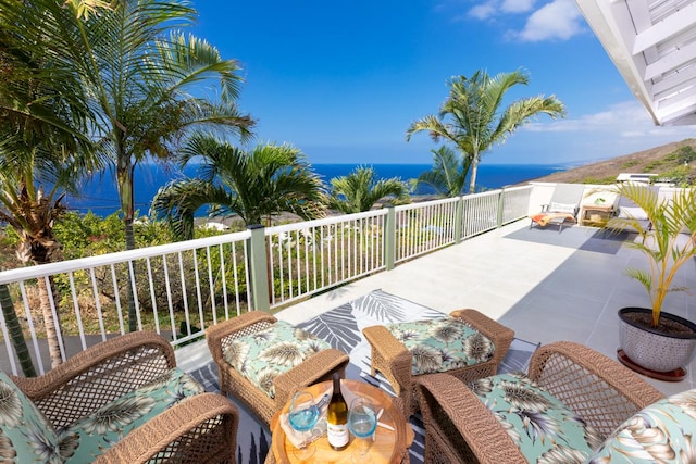 view of patio with a balcony and a water view