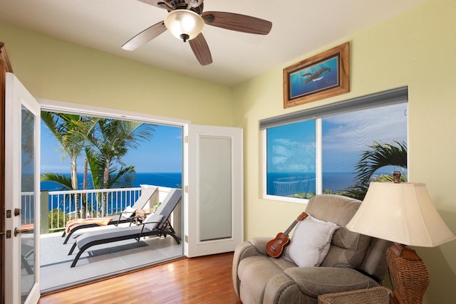 interior space featuring ceiling fan, hardwood / wood-style floors, a water view, and plenty of natural light