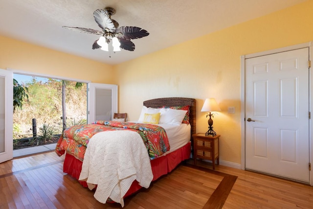 bedroom with hardwood / wood-style floors, ceiling fan, and access to outside