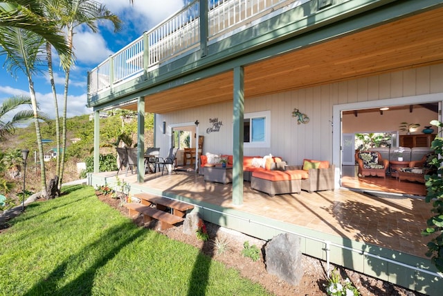 rear view of property featuring an outdoor living space, a patio area, a yard, and a wooden deck