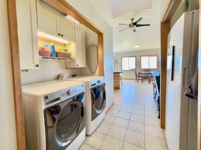 washroom featuring ceiling fan, washer and clothes dryer, light tile patterned flooring, and cabinets